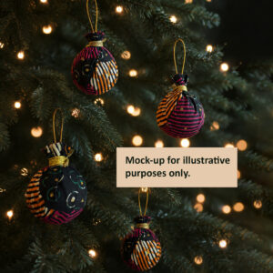 three African fabric baubles in a christmas tree, with gold hanging thread.